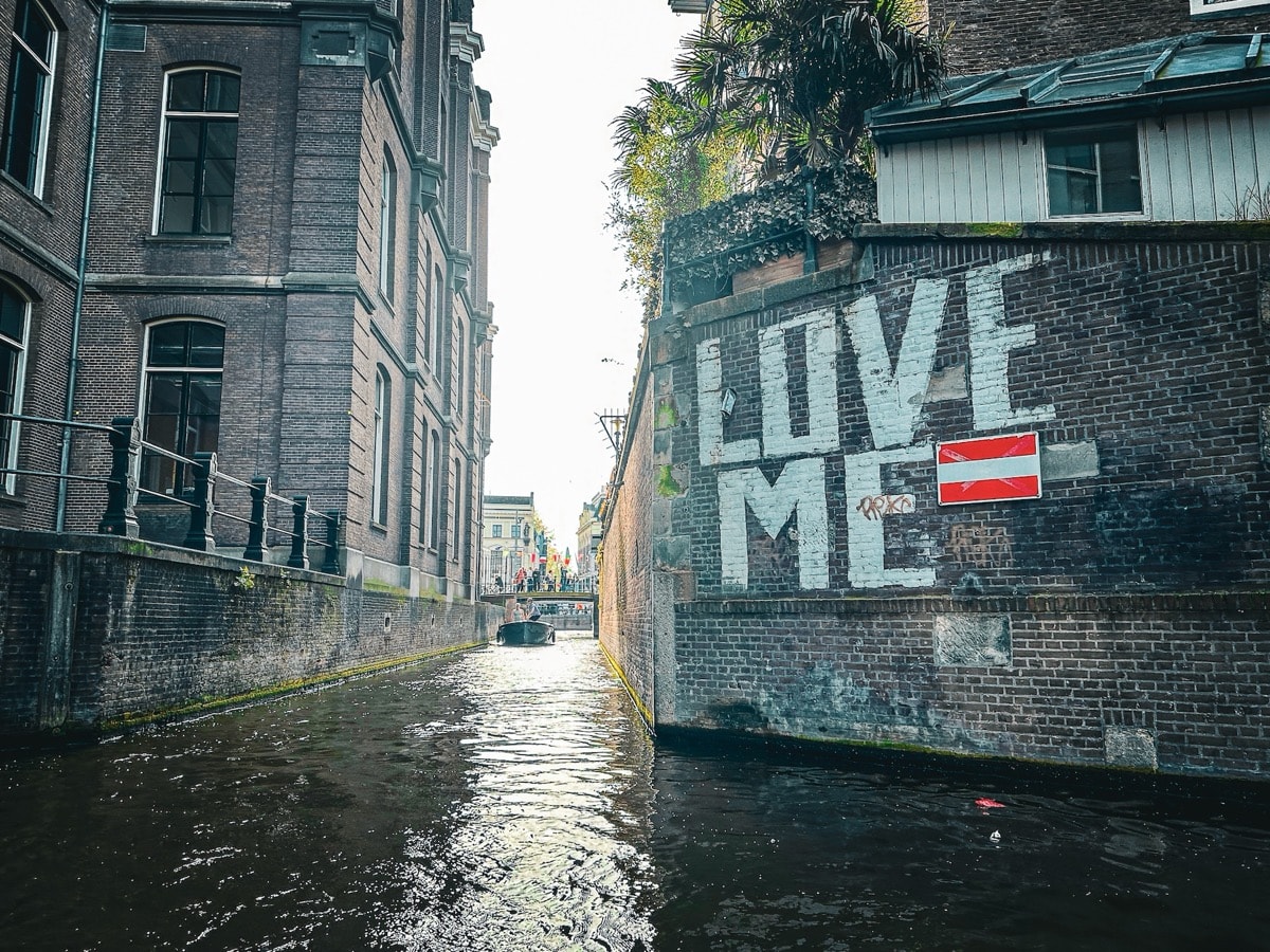 Beautiful Amsterdam canal with traditional houseboats and historic architecture
