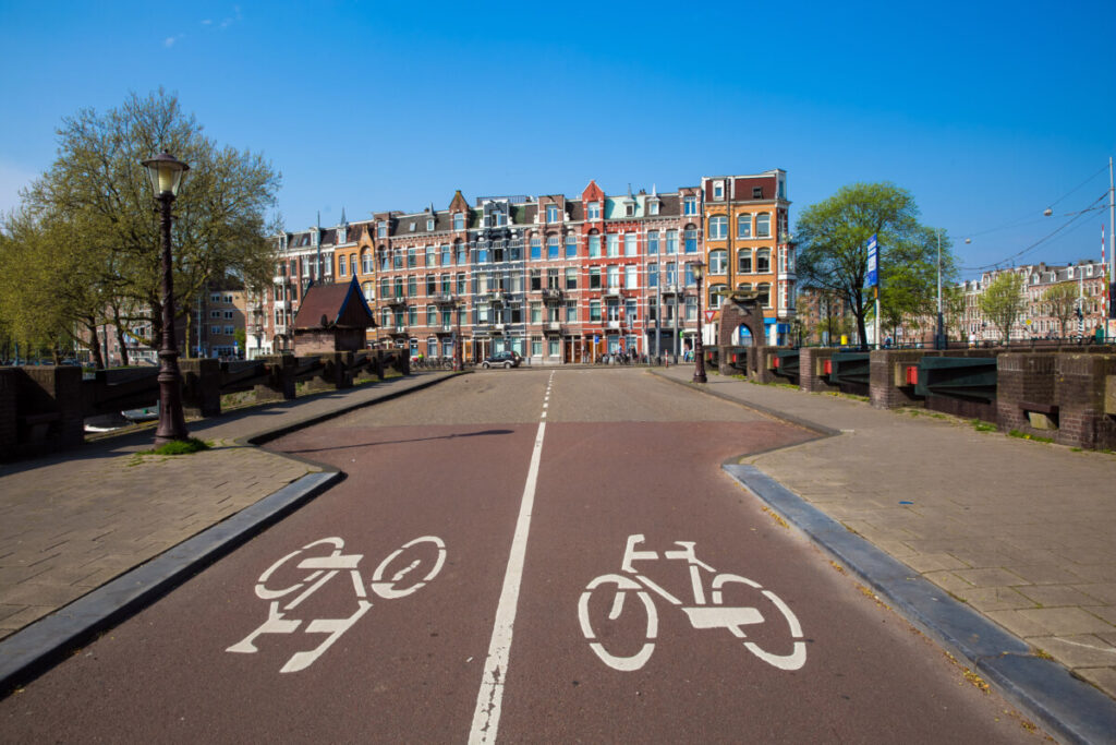 Panoramic view of bike lane sign and houses in Amsterdam , Netherlands