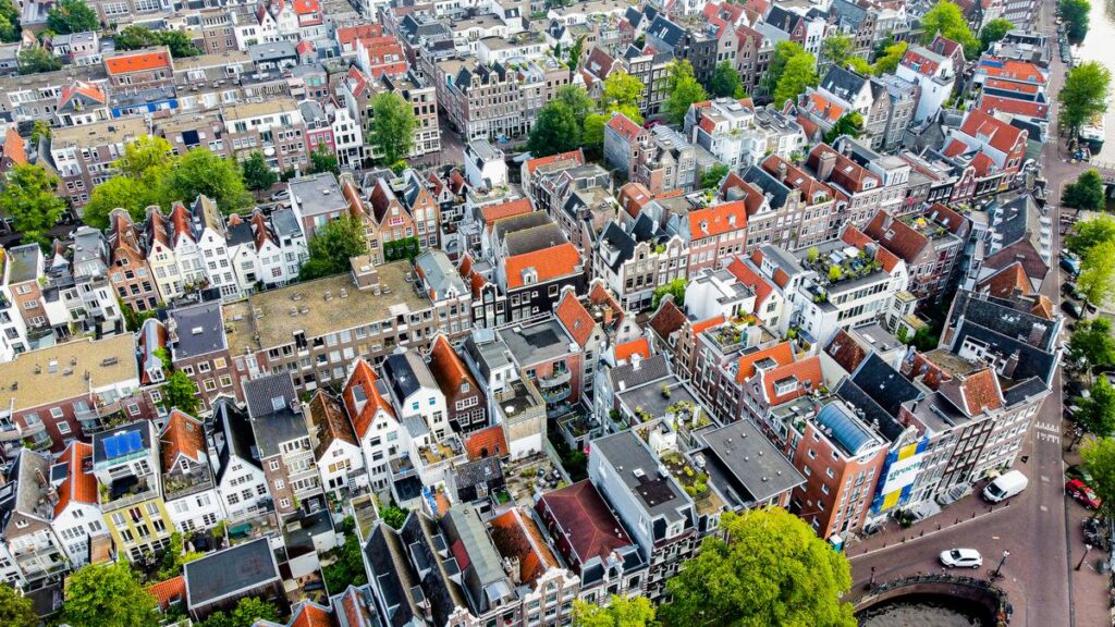 Aerial view of traditional Dutch canal houses in Amsterdam's historic district.