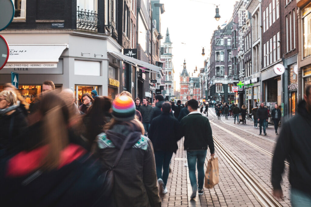 Locals and tourists walking and exploring the city center of Amsterdam, Netherlands