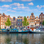 Panoramic view of Amsterdam's historic city center, featuring traditional houses