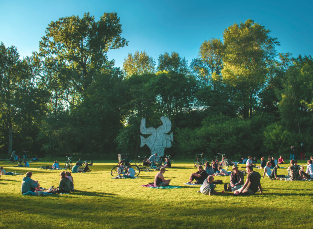 Panoramic view of the Vondelpark green scenery and young crowd relaxing in Amsterdam, Netherlands