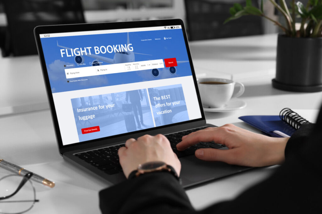 Woman using laptop to search and book flight online