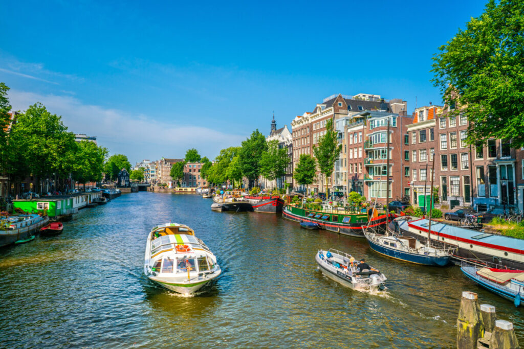 Canal cruise and a scenic sail on a small pleasure boat through the Oudeschans Canal in Amsterdam, Netherlands