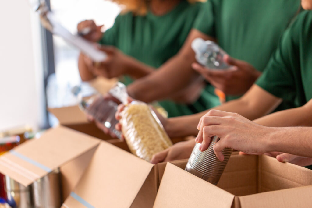 Charity volunteers packing food in boxes