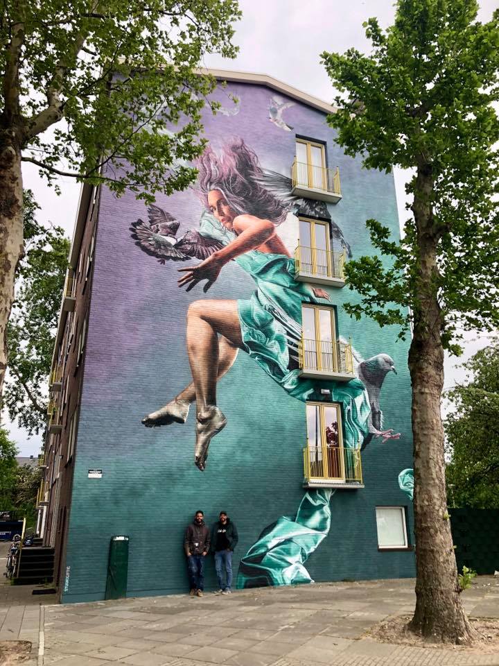 Mural titled "Floating Woman" by Studio Giftig, featuring a vibrant, abstract depiction of a woman in a whimsical pose in Amsterdam