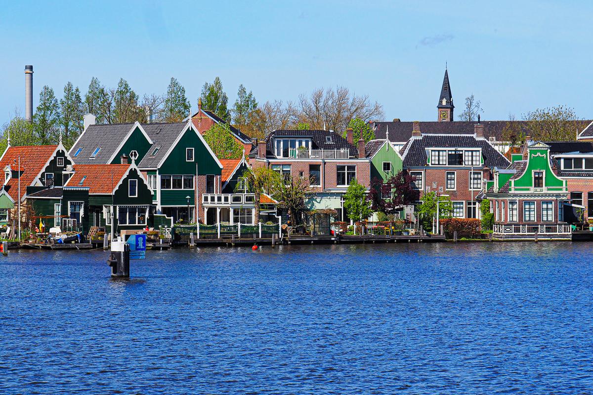 Historic houses at the Zaanse Schans by the river and the charm of the Netherlands