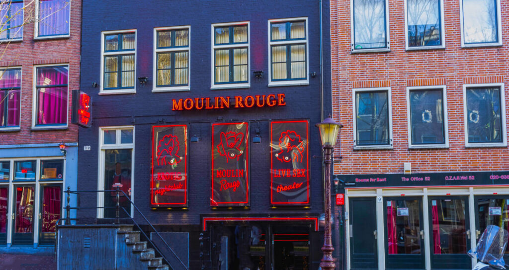 Moulin Rouge building and other establishments at the Red Light District in Amsterdam, Netherlands