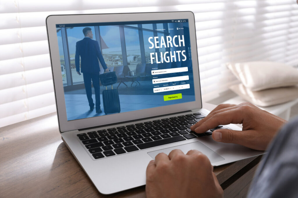 Using a laptop searching and booking a flight online