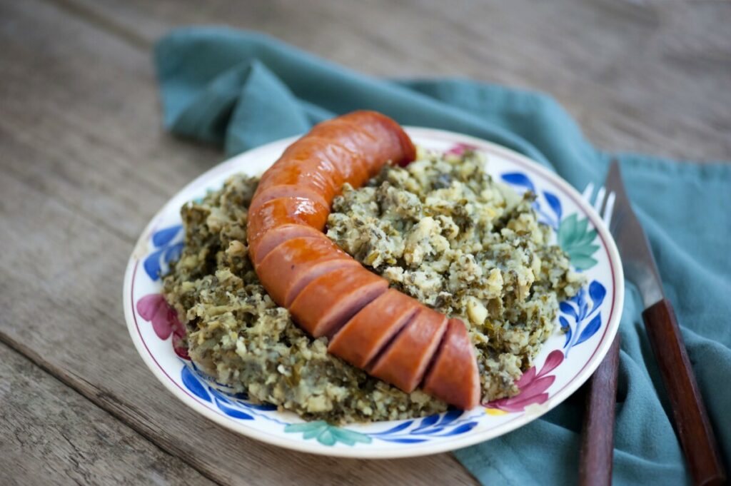 Close-up of a traditional Dutch food Stamppot with sausage and cabbage