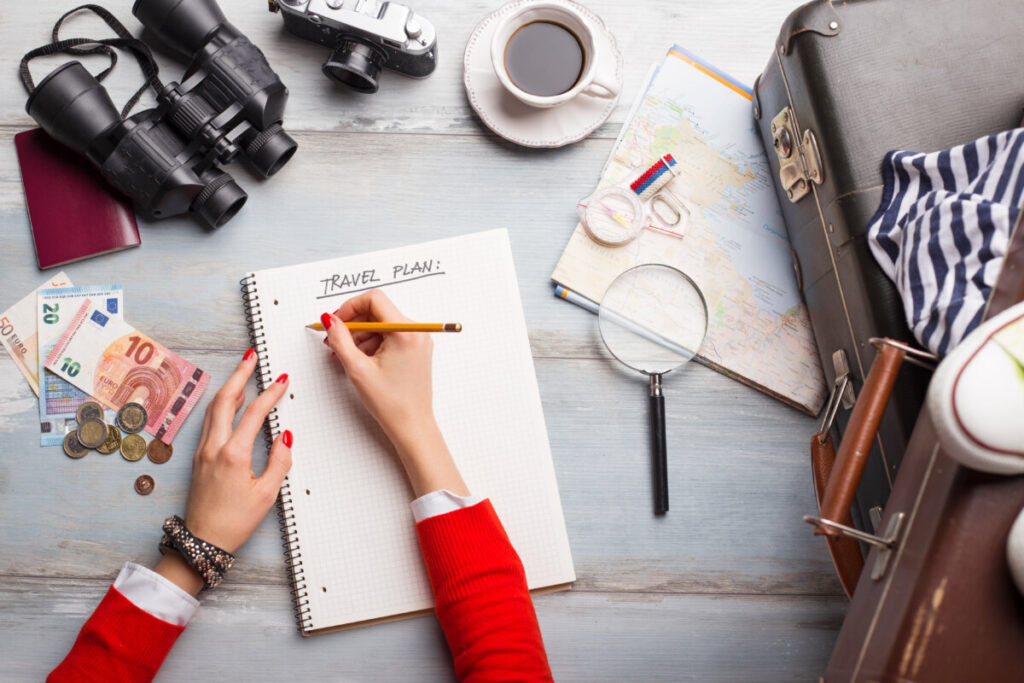 Woman with a notebook making a travel plan